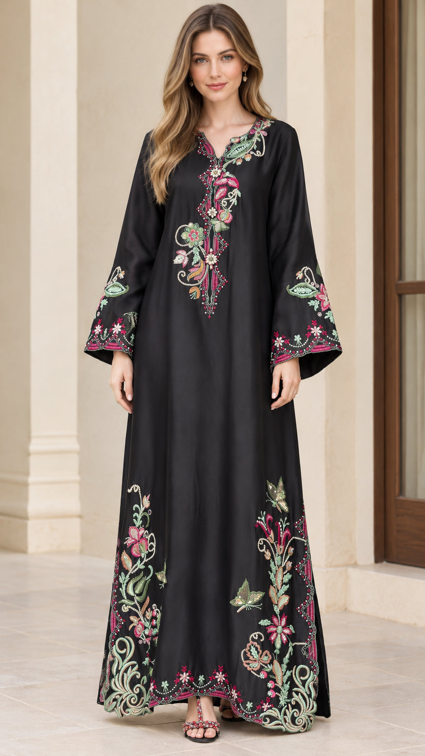 Front full-length view of model wearing black embroidered maxi kaftan dress with bell sleeves