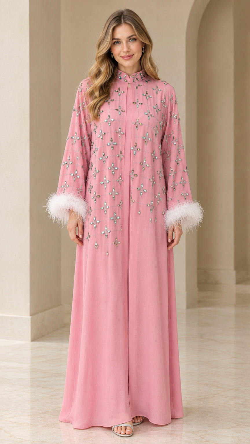 Front full view of dusty pink rhinestone embellished maxi kaftan dress with white feather cuffs