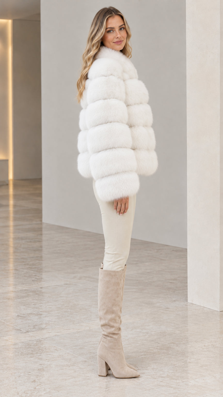 Side profile of model wearing white tiered faux fur cropped jacket