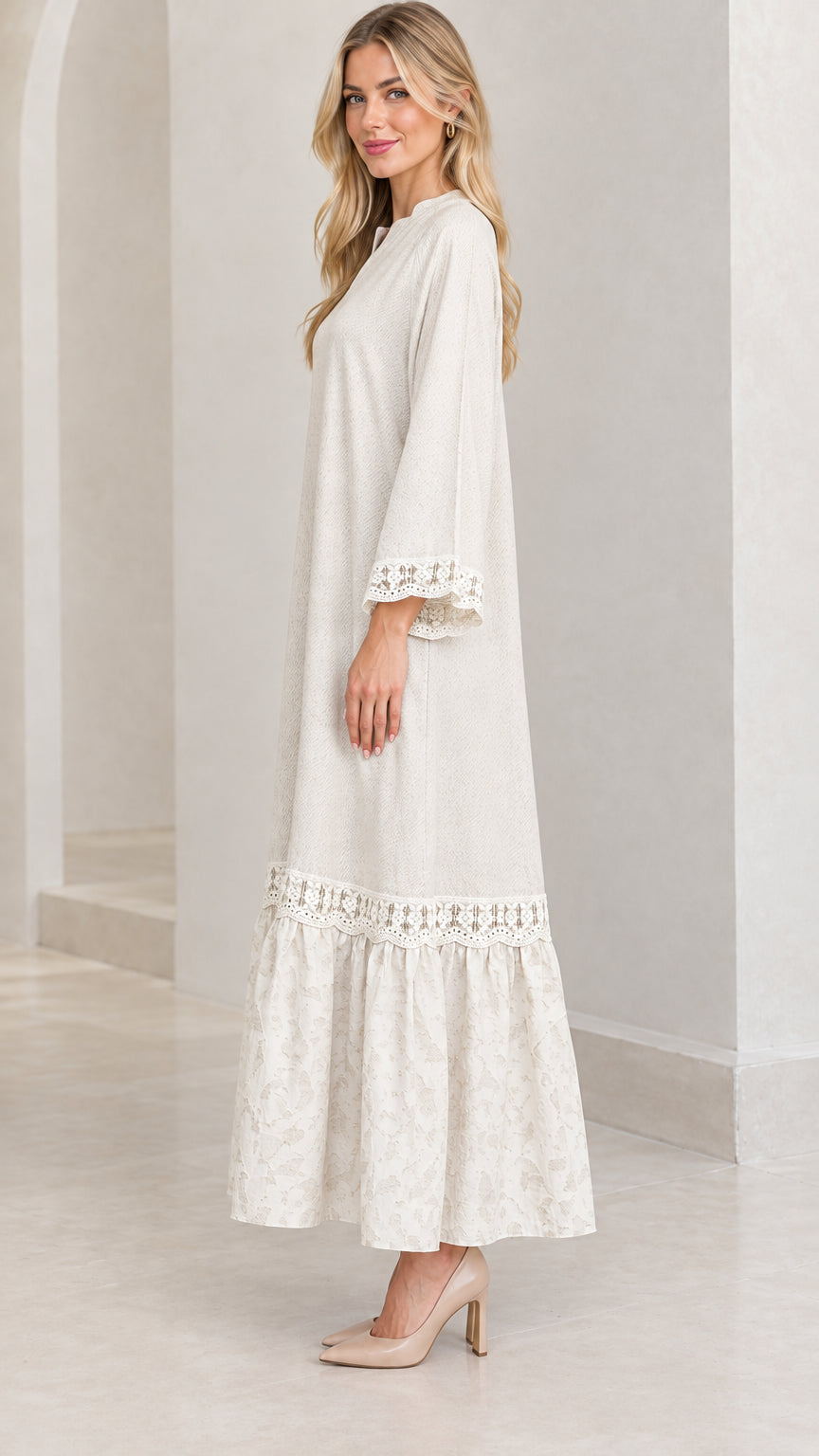 Side profile view of woman wearing cream relaxed tiered maxi dress