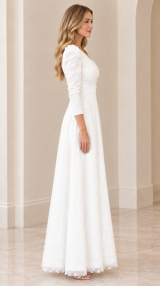 Side view of woman posing in floor-length white lace formal dress