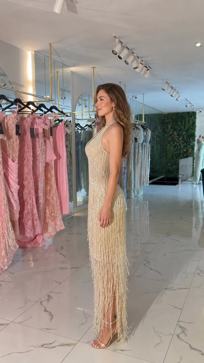 Side profile view of Champagne halter plunge fringe evening dress