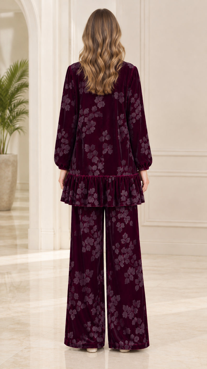 Back view of model showing burgundy floral velvet long tunic and matching pants