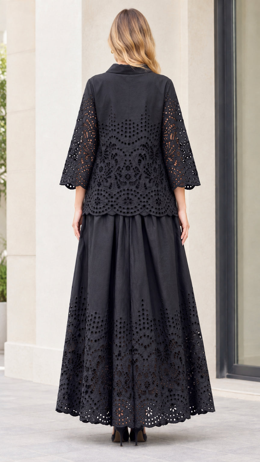 Back full-length view of woman wearing black embroidered two-piece long skirt set
