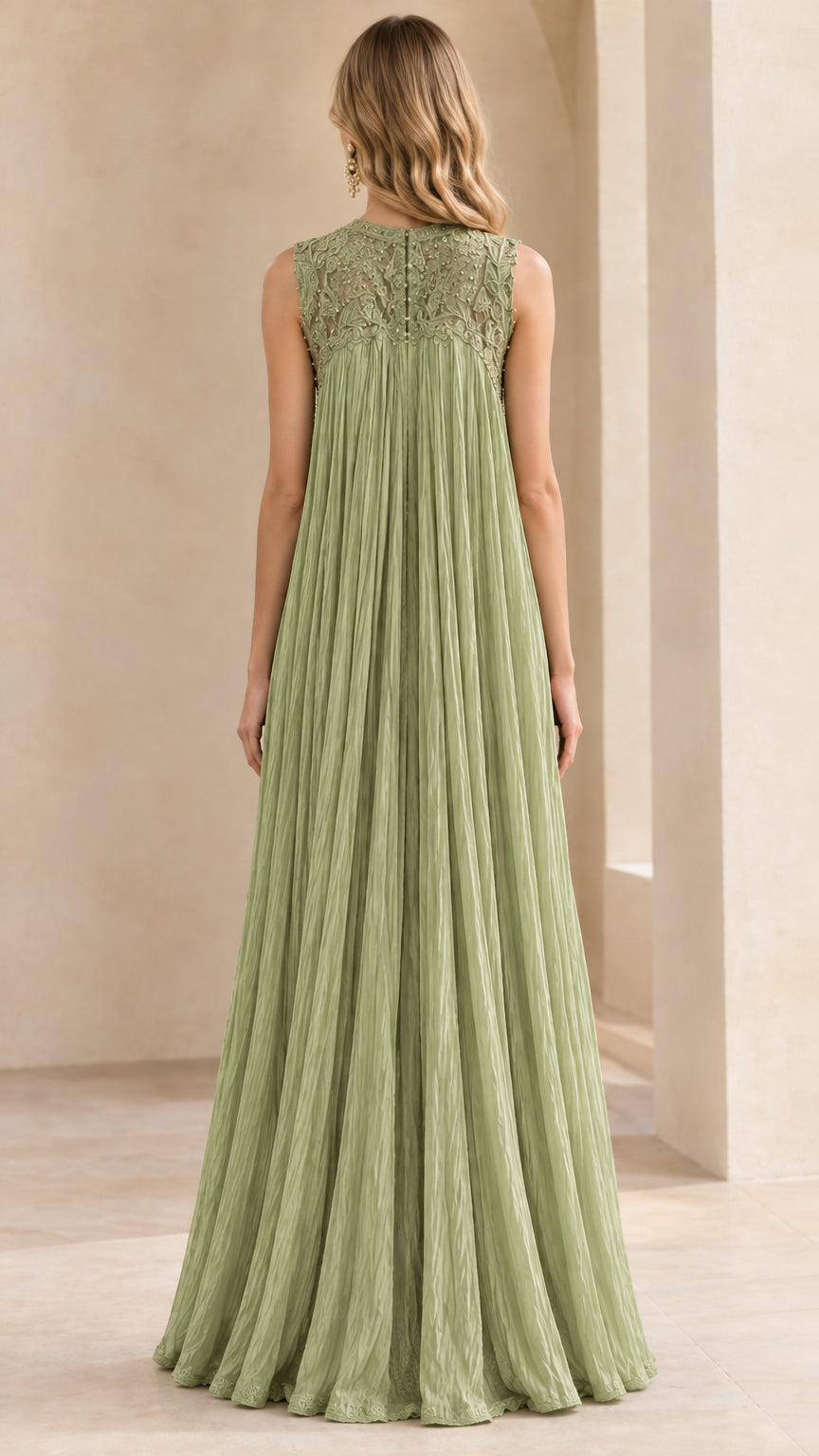 Back view of woman wearing sage green pleated sleeveless evening tunic