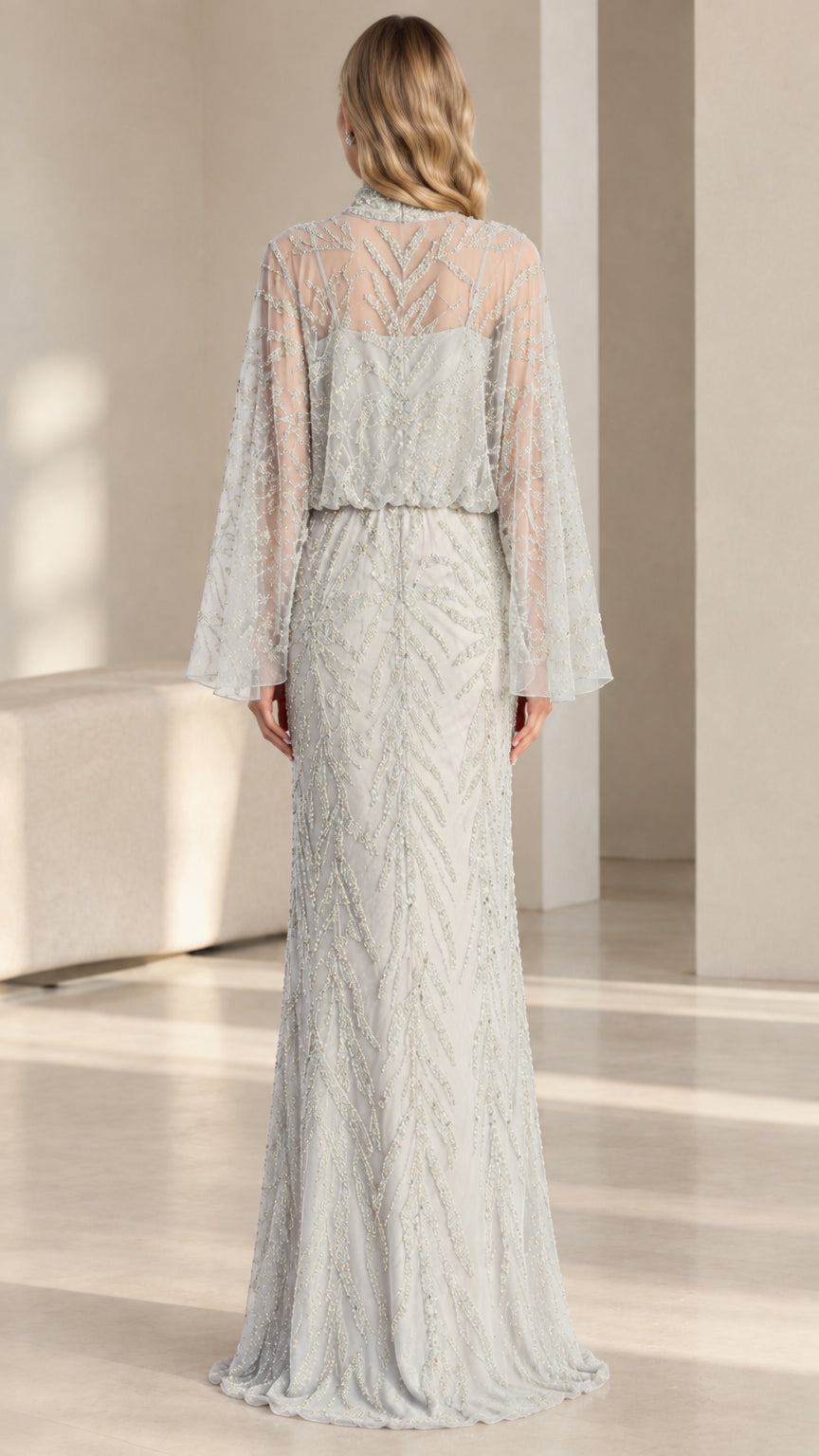 Back view of woman wearing silver floor-length embellished evening gown