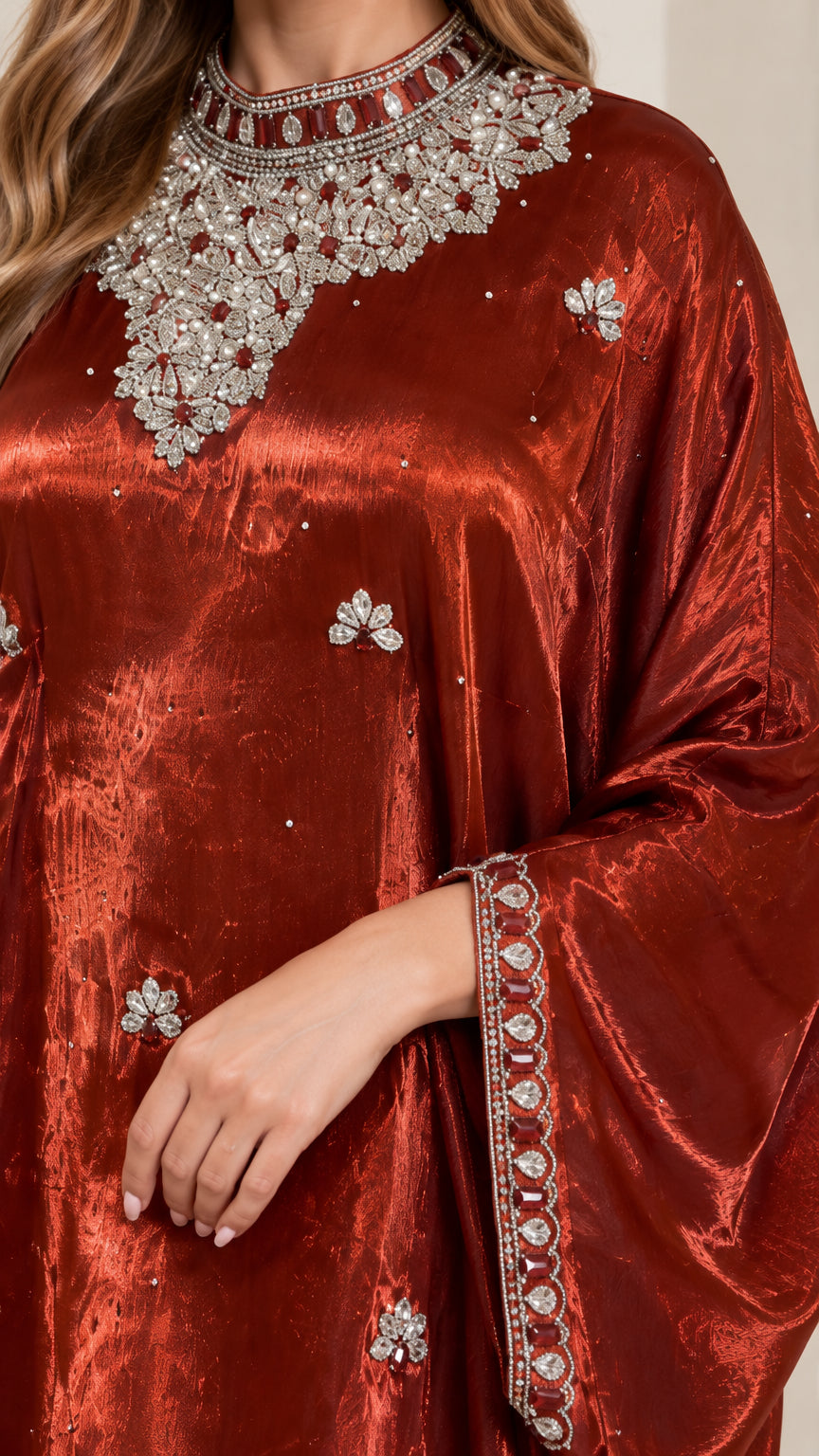Close-up detail of ornate crystal and rhinestone beadwork on the neckline and cuff