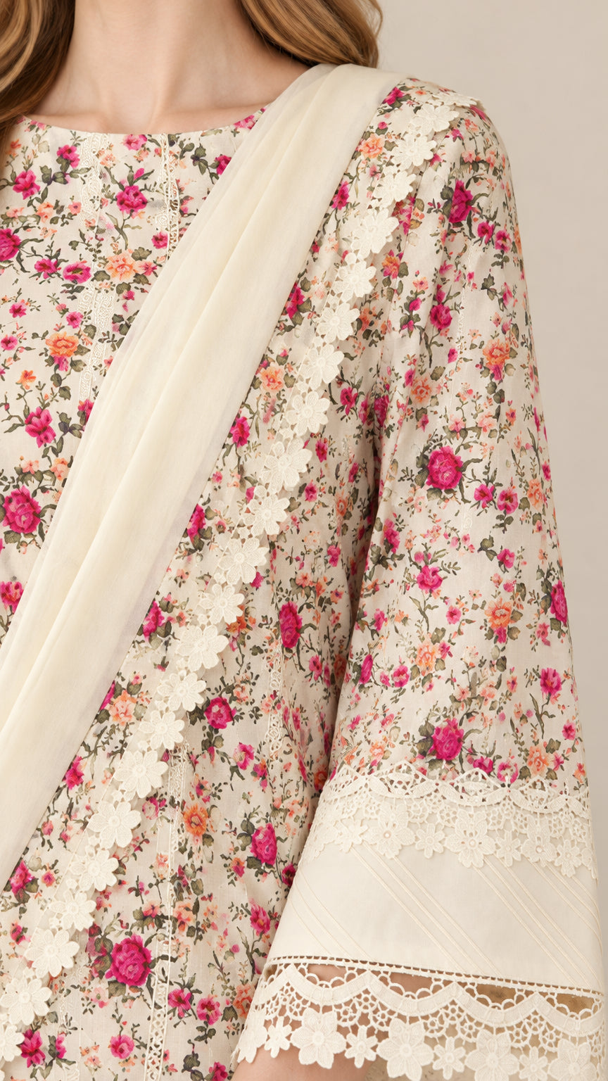 Close-up detail of floral pattern, boat neckline, and intricate lace sleeve cuff