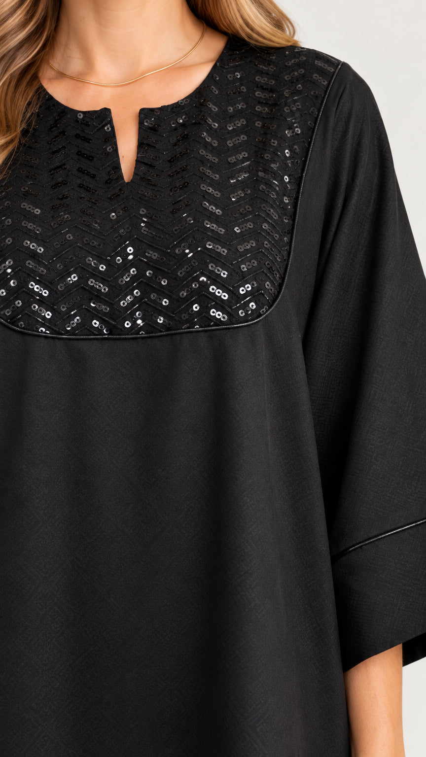 Close-up detail of notched neckline with shimmering black sequin embellishment