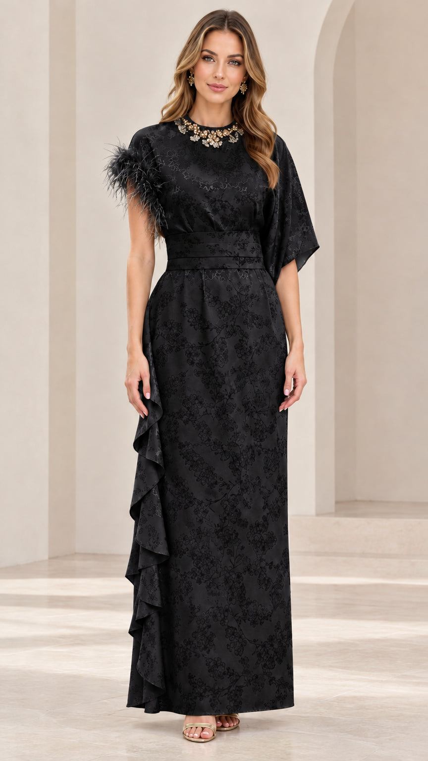 Model wearing black embellished floral jacquard formal maxi gown with feather accent