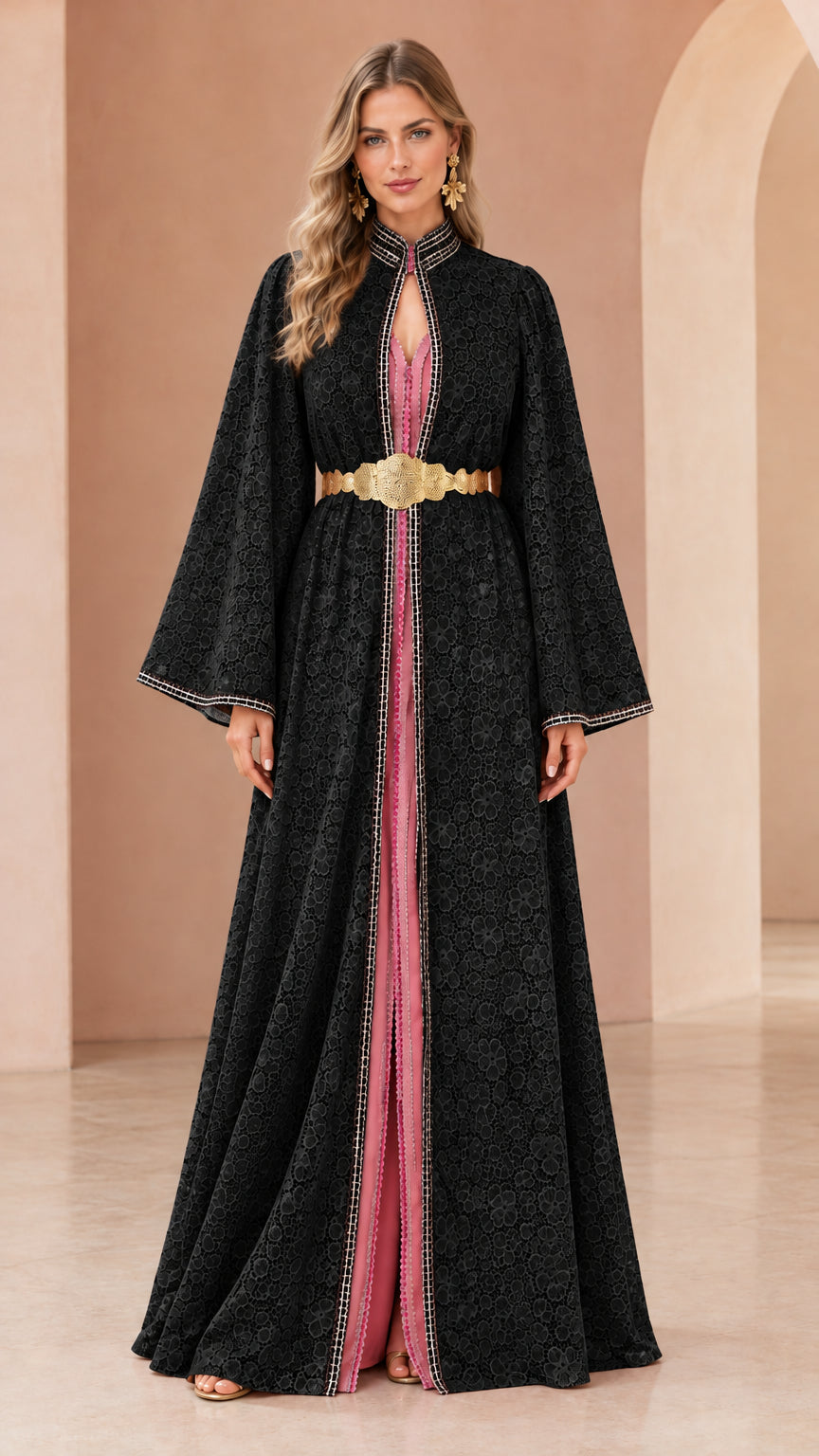 Woman wearing black floral lace kaftan maxi dress with gold belt