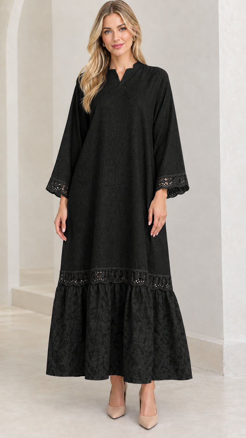 Front view of woman wearing black lace-trimmed tiered maxi dress