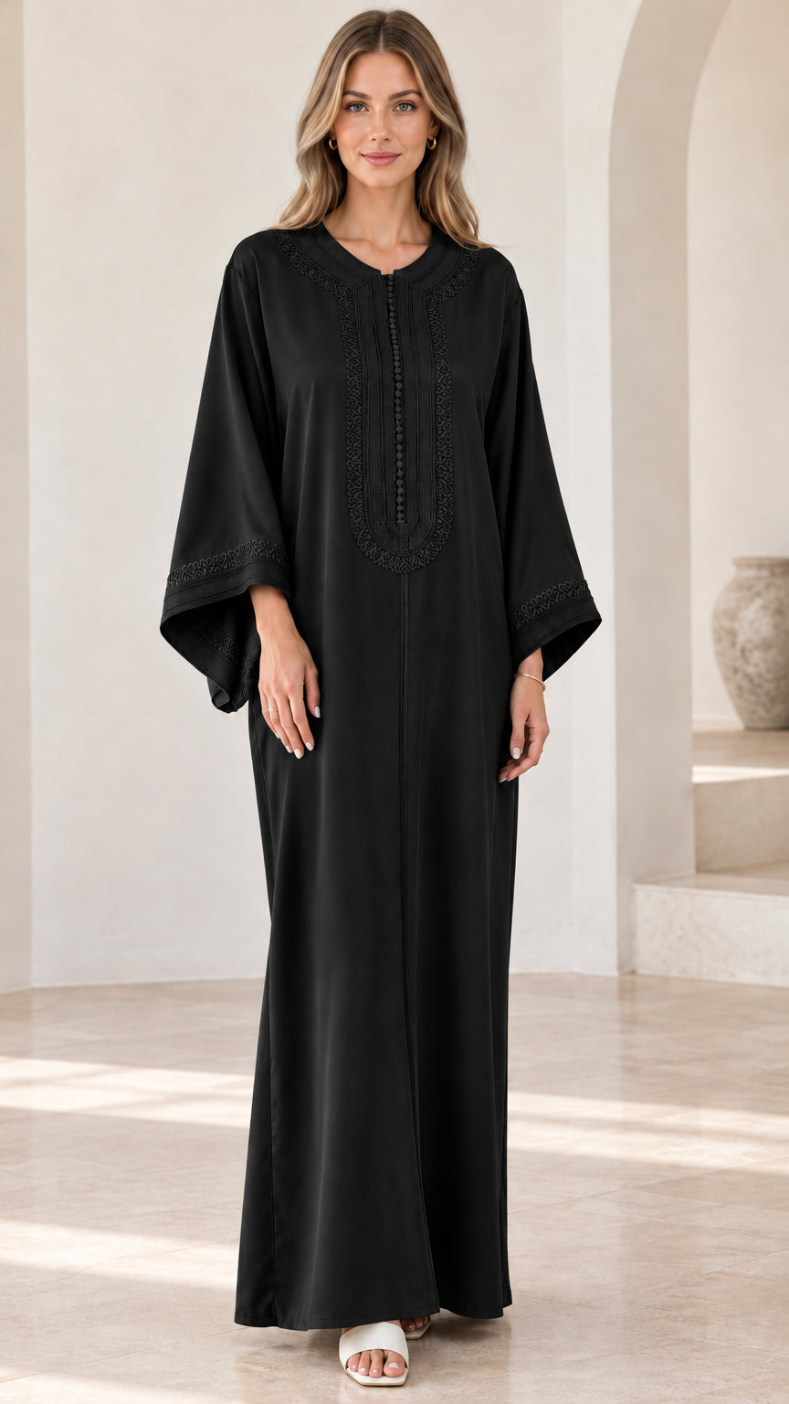 Full-length view of woman wearing black embroidered kaftan maxi dress