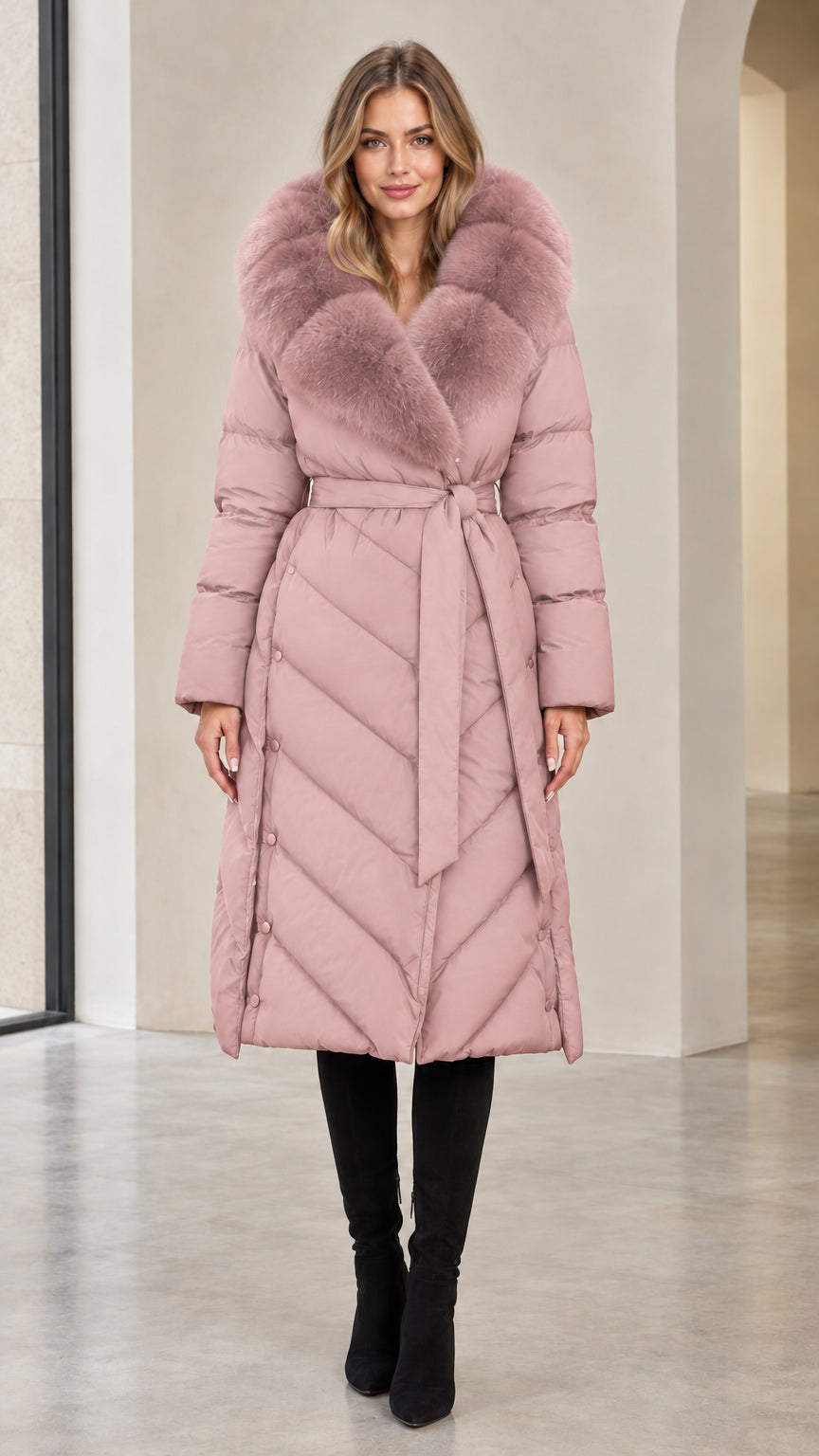 Full-length view of woman in dusty pink belted long winter puffer coat with matching fur trim