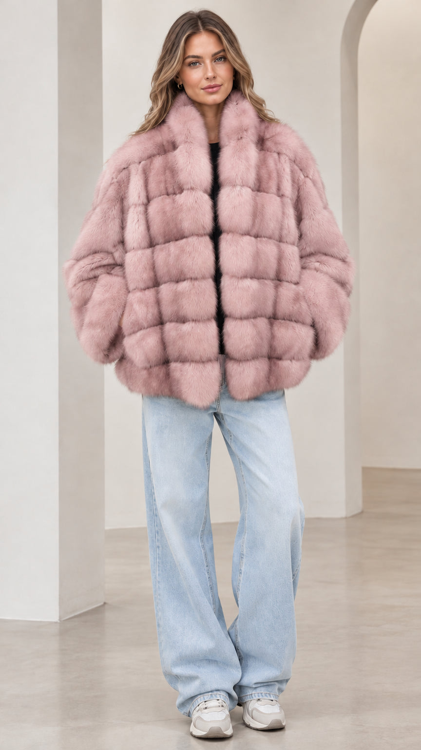 Front view of model wearing the dusty pink paneled faux fur jacket