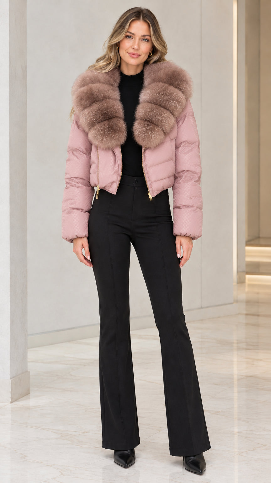 Model wearing dusty pink cropped puffer jacket with matching plush faux fur collar and black trousers