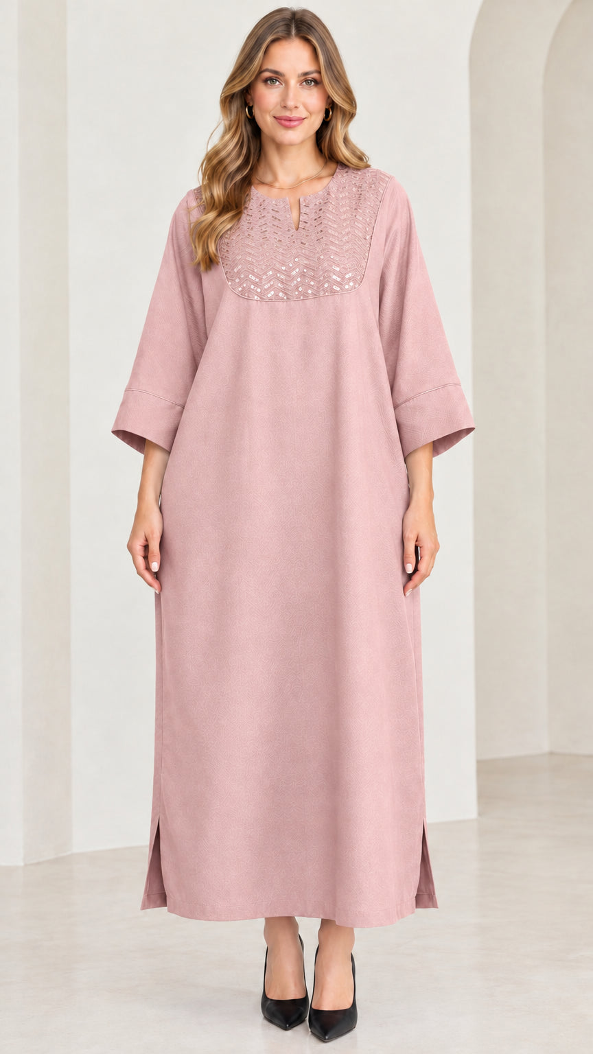 Front view of woman wearing dusty pink sequin kaftan maxi dress