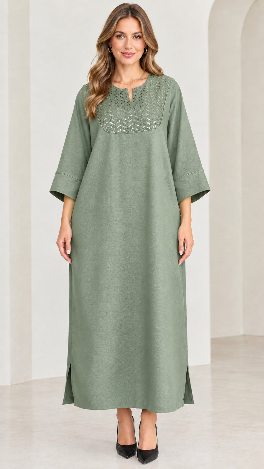 Front view of woman wearing sage green sequin kaftan maxi dress