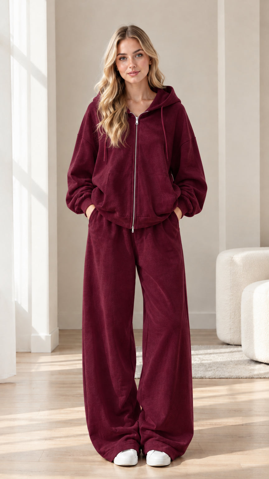 Woman wearing burgundy wine red zip-up hoodie and wide-leg sweatpants set