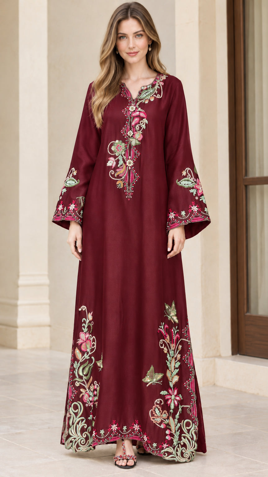 Model wearing burgundy red ornate embroidered maxi kaftan dress