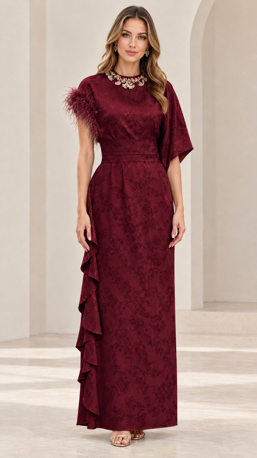 Model wearing rich burgundy embellished jacquard maxi dress with ruffle detailing