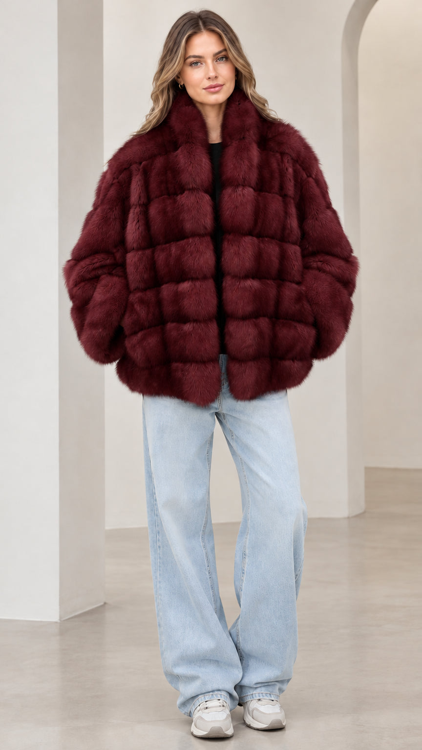 Front view of model wearing the burgundy paneled faux fur jacket