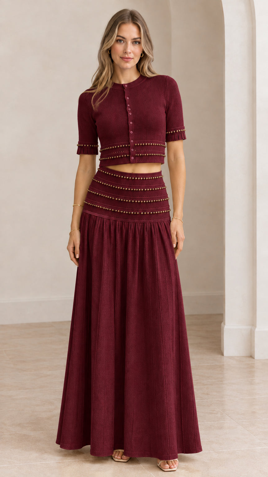Model wearing burgundy wine red beaded crop top and pleated maxi skirt set