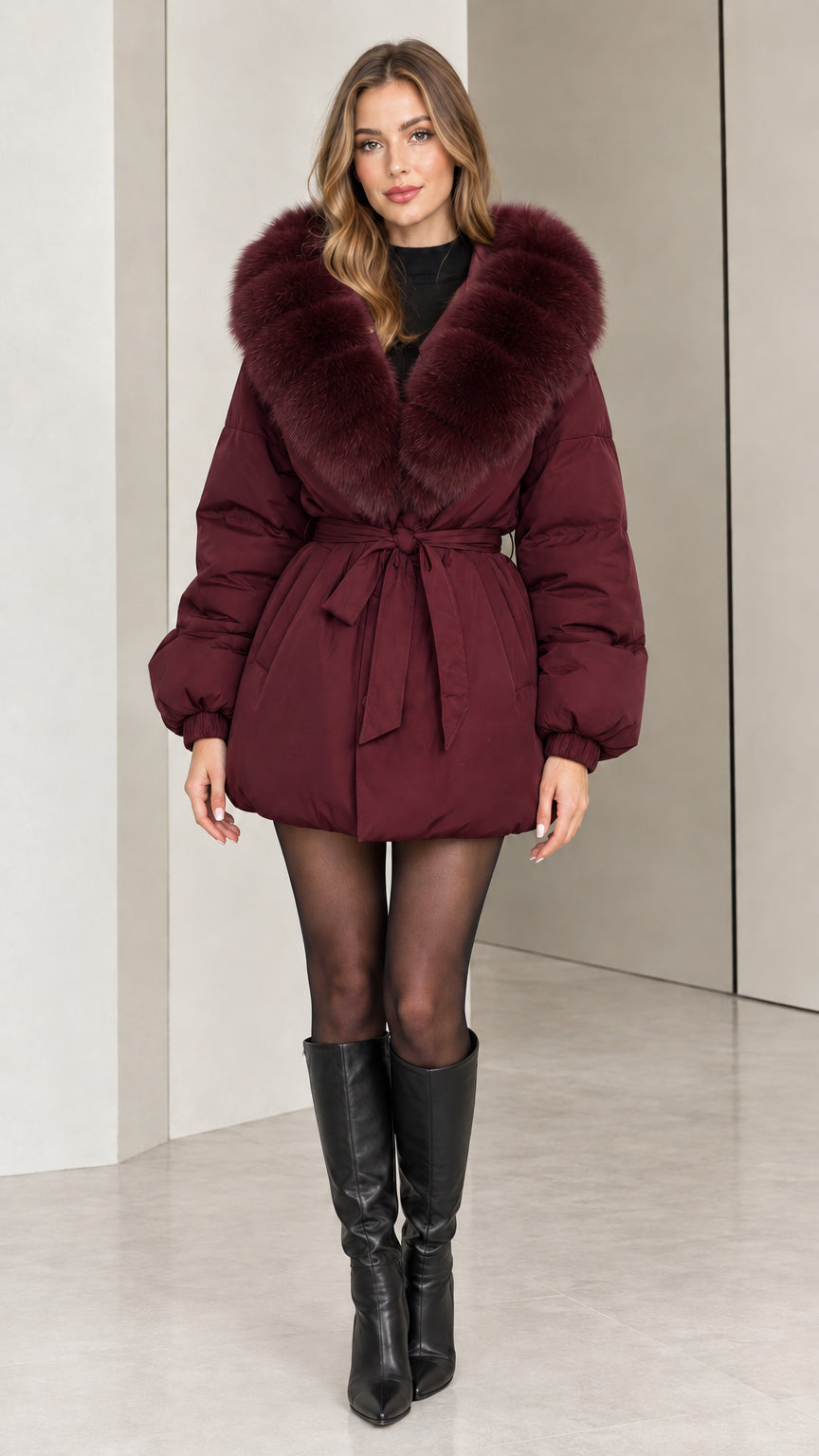 Front view of woman wearing burgundy wine red belted puffer coat with plush collar