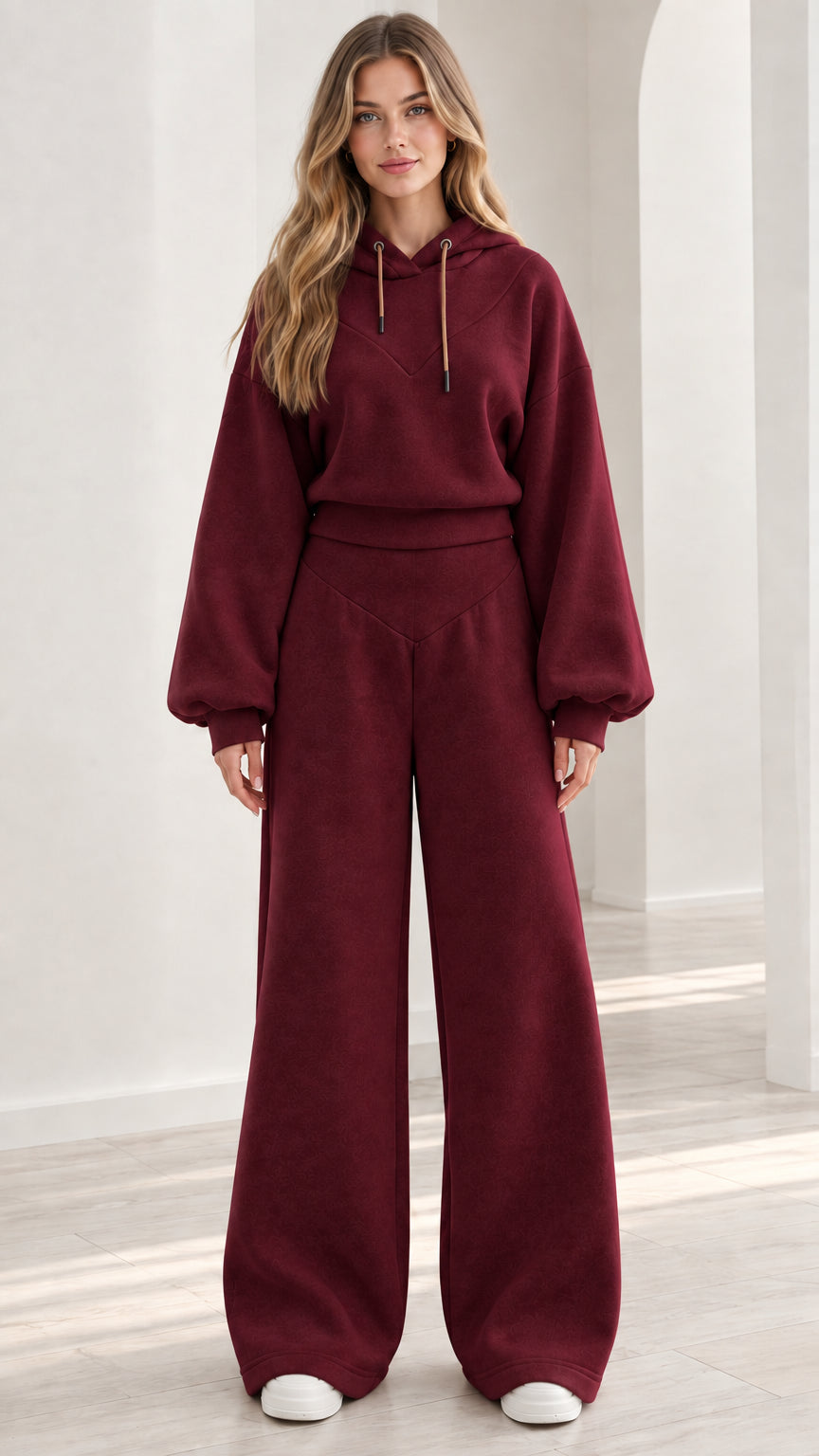 Model wearing burgundy red 2-piece fleece hoodie and wide-leg lounge set