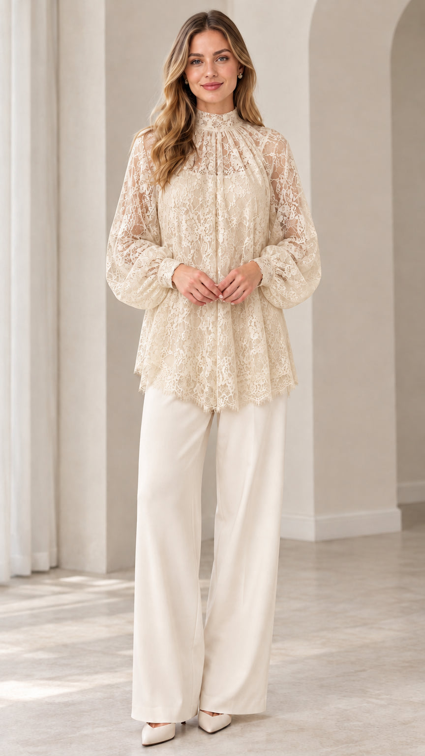 Full look of woman wearing champagne beige floral lace blouse with cream wide leg pants