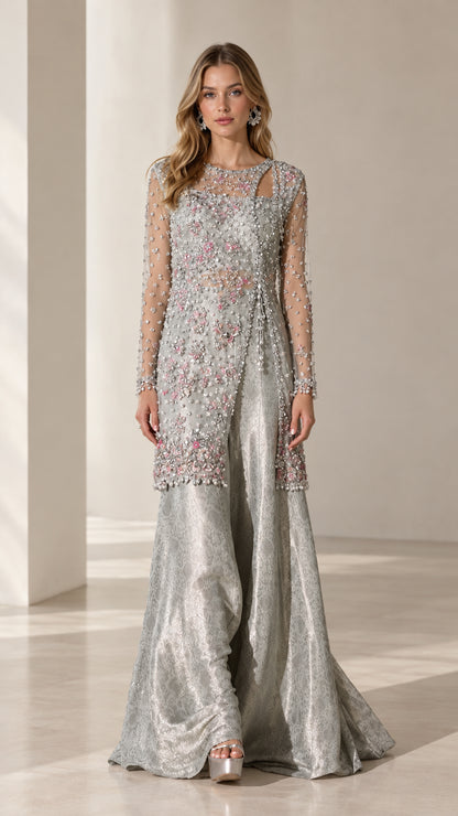 Full front view of model wearing silver embellished cutout tunic and wide-leg trousers evening set