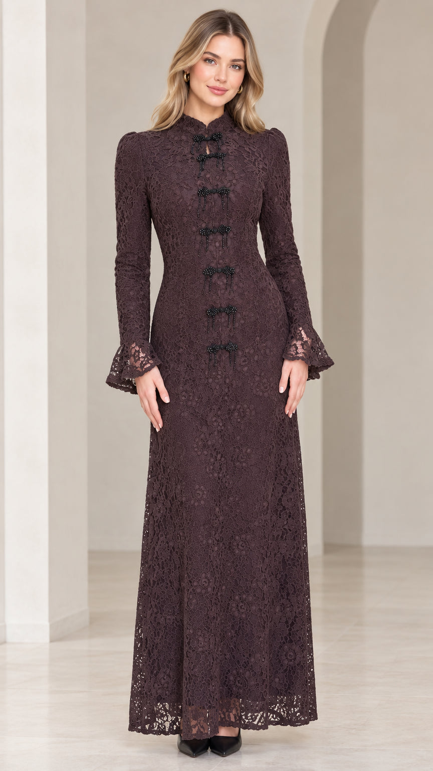 Front view of model wearing espresso floral lace maxi dress with mandarin collar and beaded frog closures