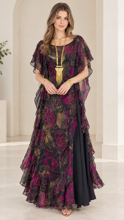 Model wearing black floral chiffon tiered ruffle maxi dress with gold necklace