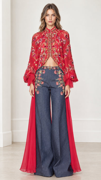 Front full-length view of model in red floral embroidered high-neck cape and wide-leg pants