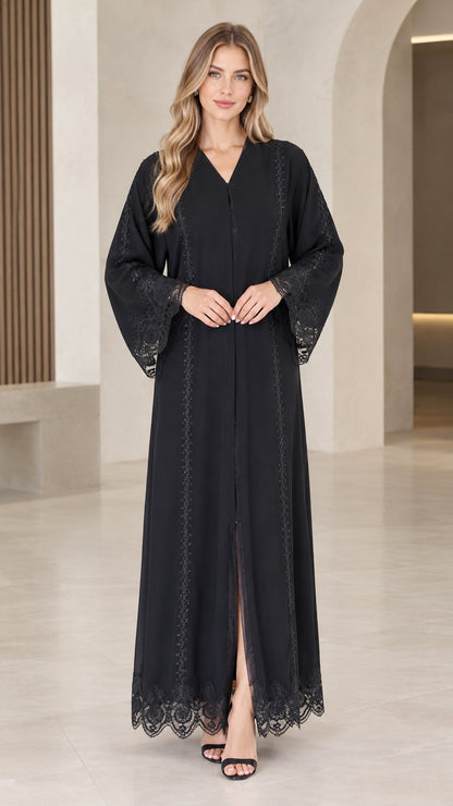 Front view of woman wearing elegant black maxi abaya dress with lace trim