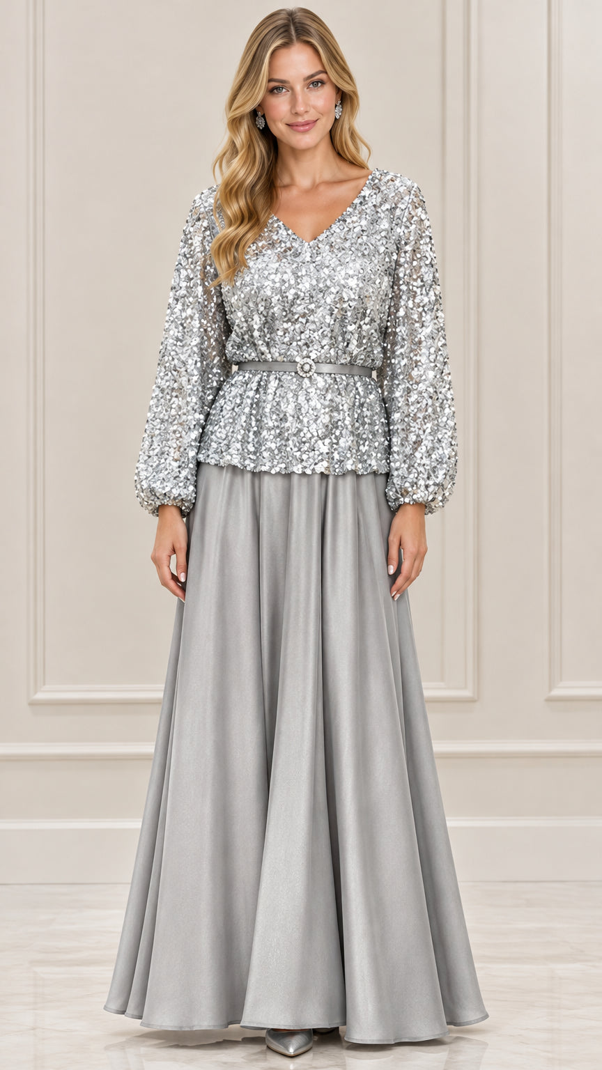Front view of woman wearing silver sequin long sleeve evening gown with belted waist