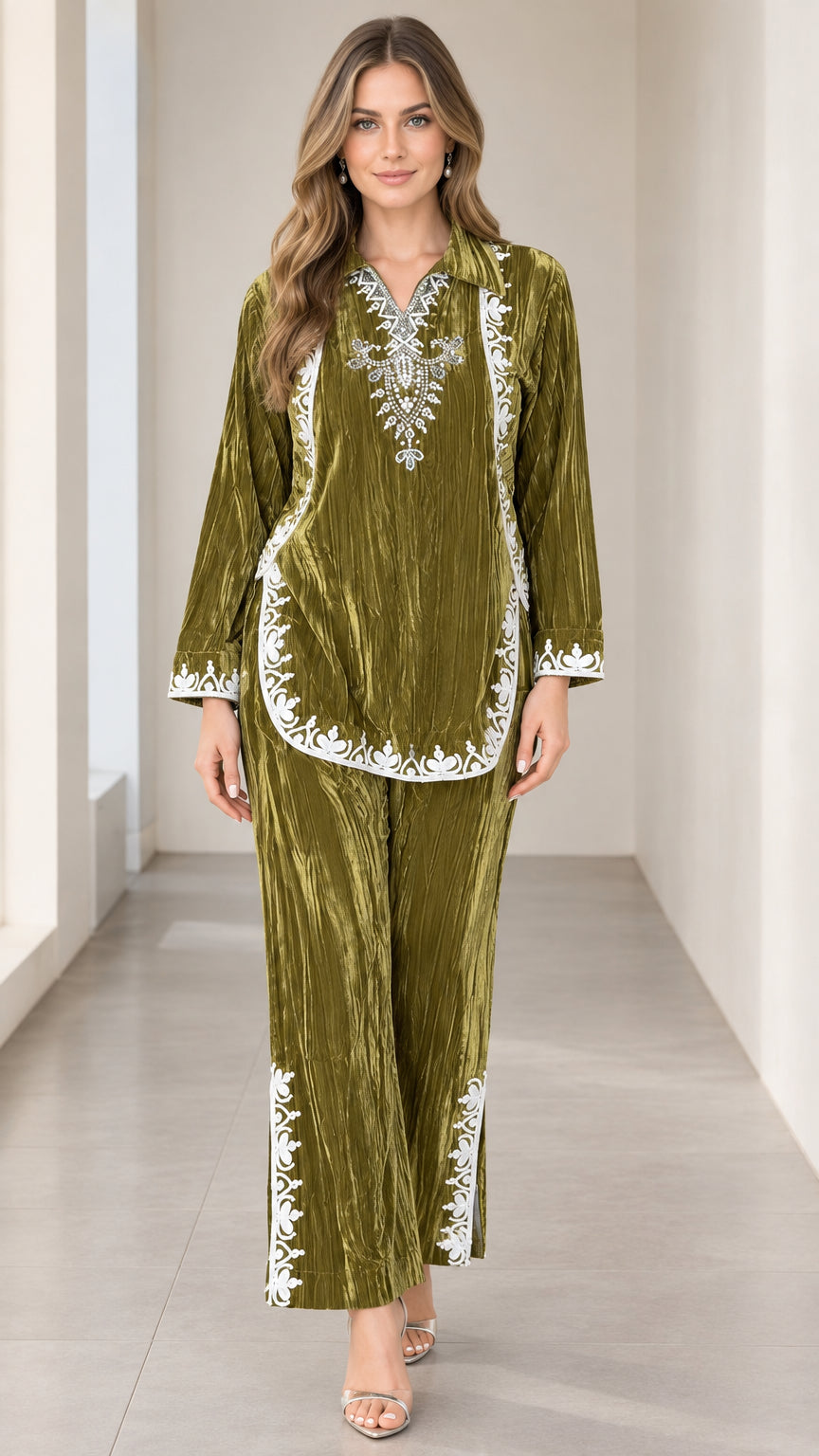 Model wearing olive green crushed velvet tunic top and pants set with white embroidery