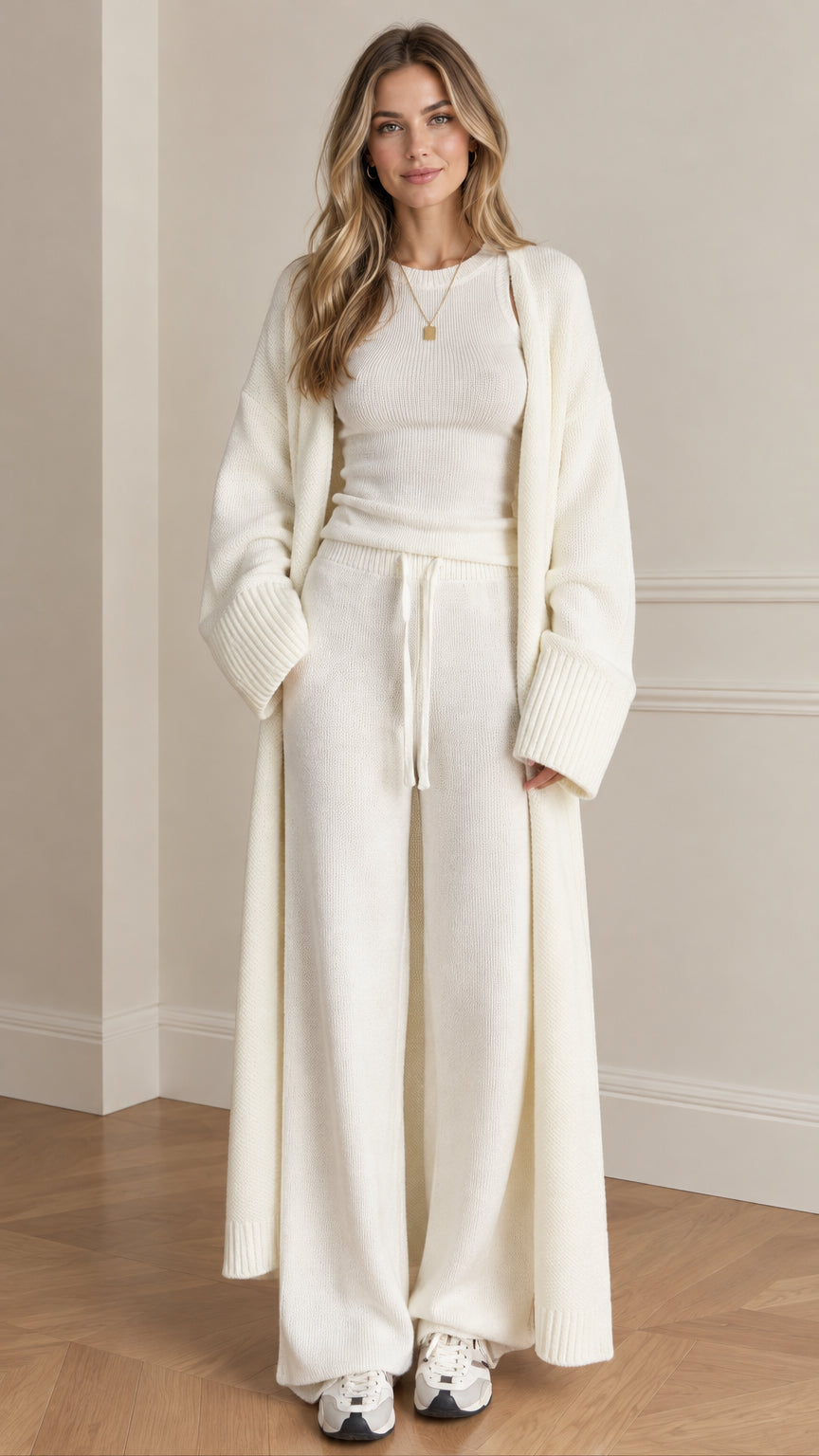 Front full view of woman wearing cream 3-piece knit lounge set with maxi cardigan and wide-leg pants