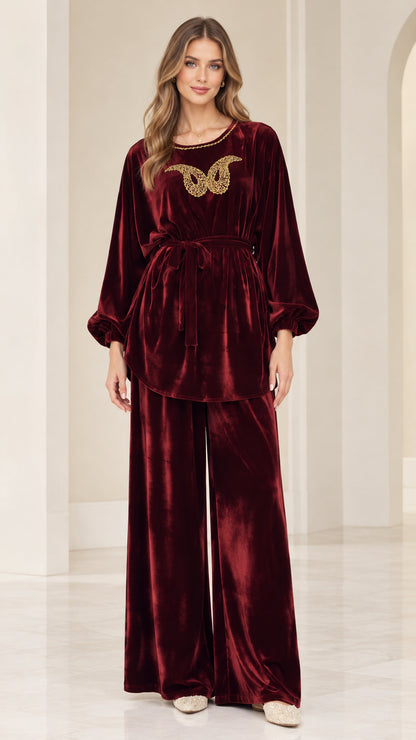 Front view of woman wearing burgundy velvet embellished tunic and wide leg pants set