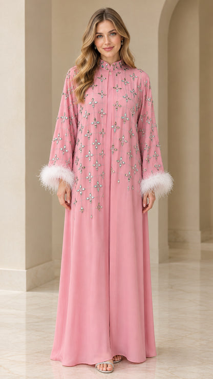 Front full view of dusty pink rhinestone embellished maxi kaftan dress with white feather cuffs