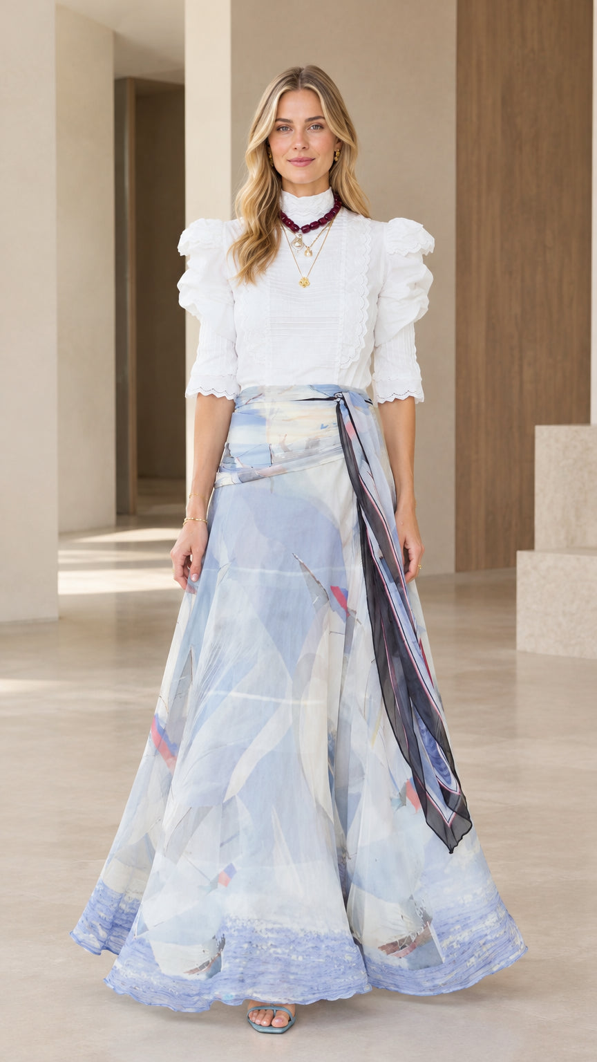 Front full-length view of woman wearing sky blue watercolor maxi skirt with white puff sleeve top