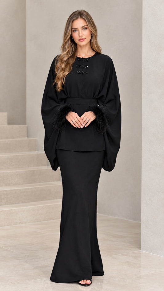 Full front view of model wearing black feather-cuff batwing tunic and maxi skirt set