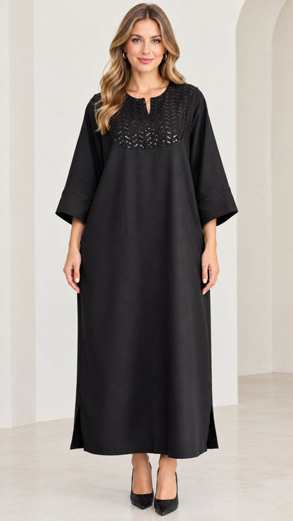 Front full-length view of woman wearing black sequin yoke kaftan maxi dress