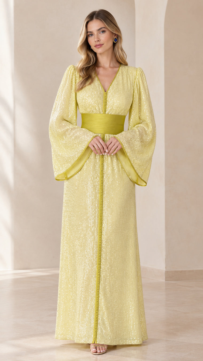 Front full-length view of woman wearing pastel yellow sequin kaftan maxi dress with wide sleeves