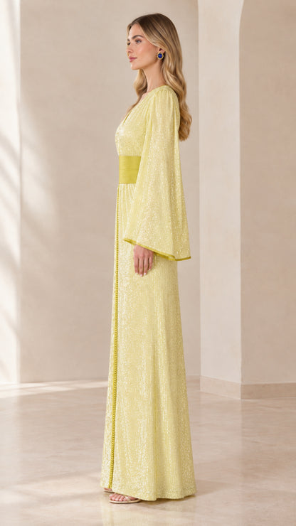 Side profile view of pastel yellow sequined evening dress with wide waistband