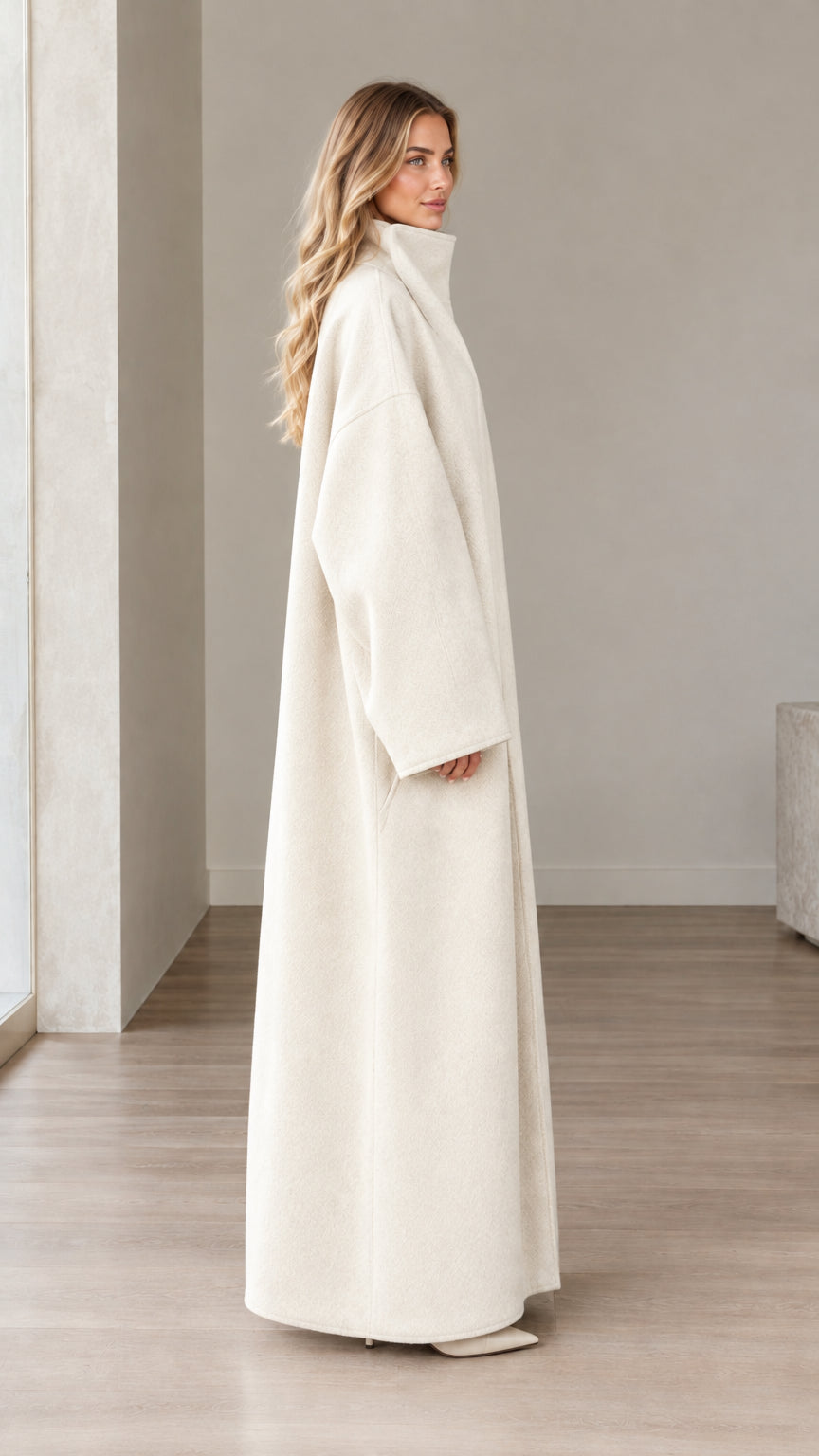 Side profile of woman in Cream floor-length stand collar coat