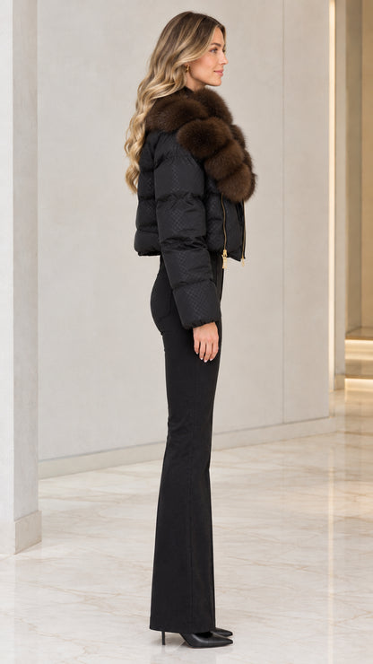 Side profile view of black cropped quilted puffer jacket with plush fur collar