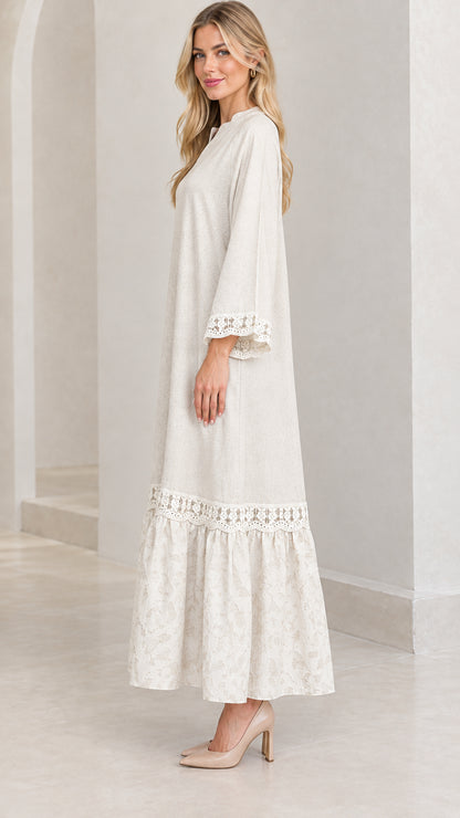 Side profile view of woman wearing cream relaxed tiered maxi dress