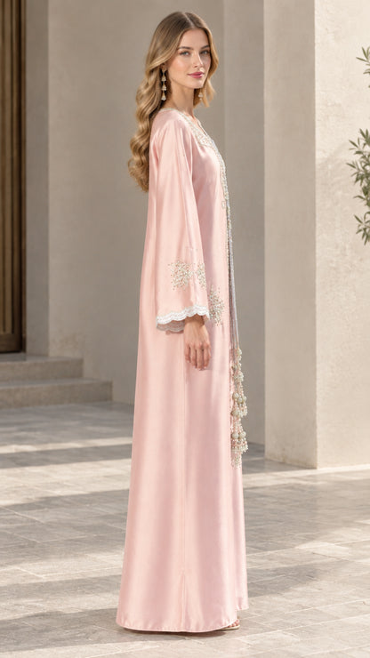 Side profile view of blush pink embroidered long sleeve kaftan dress