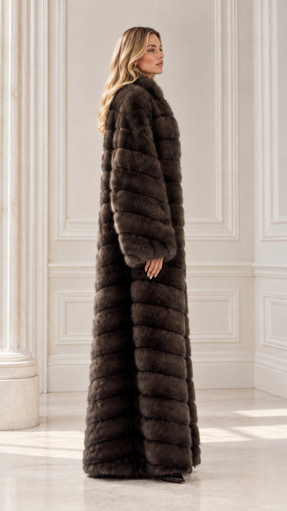 Side profile of model in full-length chocolate brown ribbed faux fur coat